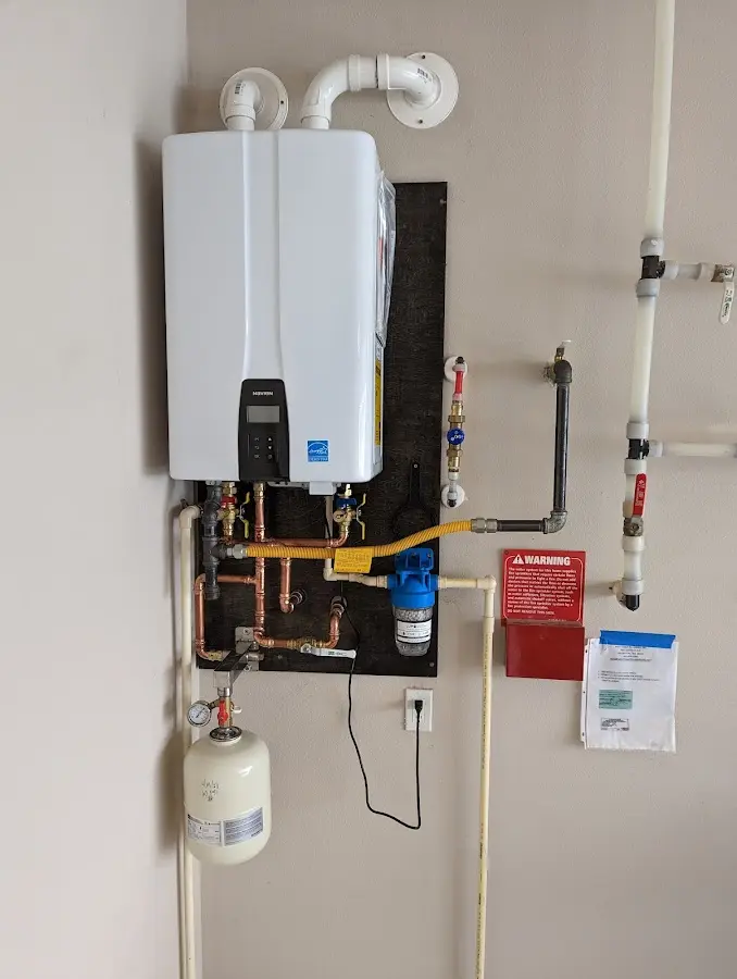 Professional plumber installing copper piping in a Gardner home